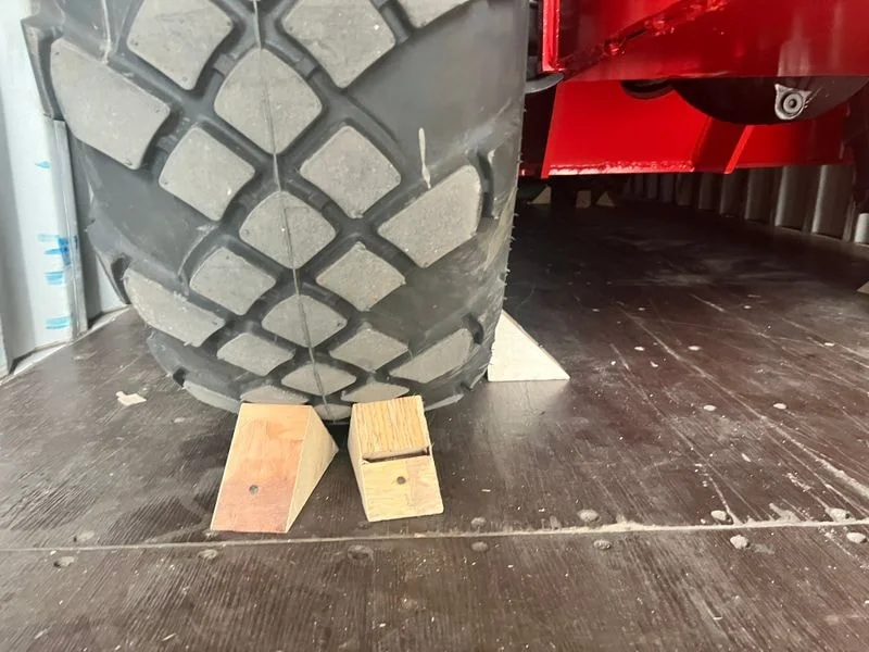 Wheel blocking and chocks preventing telehandler movement