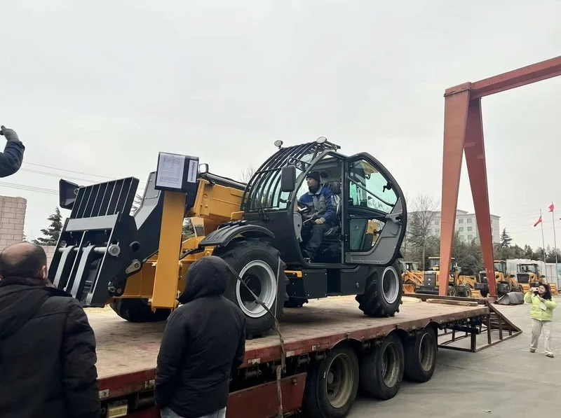 Telehandler secured on transport truck